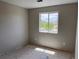 This is a bedroom with a window looking out onto a street at 317 Whimsical Ave, Brighton, CO 80603