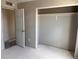Bright bedroom featuring an open closet and doorway showcasing the home's simple design at 317 Whimsical Ave, Brighton, CO 80603