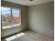 This is a bedroom with a window looking out onto another house at 317 Whimsical Ave, Brighton, CO 80603