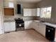 Bright kitchen featuring white cabinets, granite countertops, and stainless steel appliances at 317 Whimsical Ave, Brighton, CO 80603