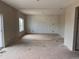 Spacious living room with decorative wall awaiting your design touches, and window viewing the back yard at 317 Whimsical Ave, Brighton, CO 80603