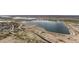 An aerial view of a large body of water surrounded by green spaces and residential areas at 10595 Boston St, Commerce City, CO 80640