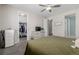 Bedroom featuring a walk-in closet, a TV, and a calming, neutral color palette at 10595 Boston St, Commerce City, CO 80640