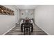 Elegant dining area with contemporary lighting, neutral walls, and stylish gray wood flooring at 10595 Boston St, Commerce City, CO 80640