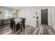 Inviting dining room features stylish wood floors, a modern chandelier, and elegant decor at 10595 Boston St, Commerce City, CO 80640