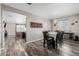 Open-concept layout showcasing the dining area with stylish flooring, decor, and ample natural light at 10595 Boston St, Commerce City, CO 80640