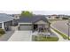 A well-maintained home with a two-car garage, cozy front porch, and neat landscaping at 10595 Boston St, Commerce City, CO 80640