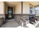 Inviting covered front porch, adorned with stone detailing and comfortable seating at 10595 Boston St, Commerce City, CO 80640