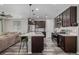 Modern kitchen featuring dark cabinets, stainless steel appliances, and a center island with seating at 10595 Boston St, Commerce City, CO 80640
