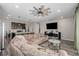 Open living space featuring a large sectional, entertainment center, and a modern kitchen with a central island at 10595 Boston St, Commerce City, CO 80640