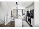 A bright kitchen that flows into the living room, featuring stainless steel appliances and granite island with seating at 2862 S Galapago Ct, Englewood, CO 80110