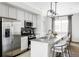 The kitchen has stainless steel appliances, a granite island with seating, and a window overlooking the dining area at 2862 S Galapago Ct, Englewood, CO 80110