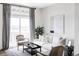 Bright and airy living room with large window, white couch, and artwork at 2862 S Galapago Ct, Englewood, CO 80110