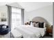 Bright main bedroom featuring a large window with city views, a sitting area and a decorative headboard at 2862 S Galapago Ct, Englewood, CO 80110