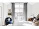 Bright bedroom featuring a large window with city views and a comfortable sitting area at 2862 S Galapago Ct, Englewood, CO 80110
