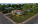 Aerial view of a home featuring front yard landscaping, a lawn, and mature trees at 12017 W 58Th Pl, Arvada, CO 80004
