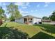 Backyard with a well-manicured lawn and a covered patio with grilling area at 12017 W 58Th Pl, Arvada, CO 80004