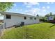 Spacious backyard and well-maintained lawn with an air conditioning unit at 12017 W 58Th Pl, Arvada, CO 80004