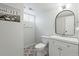 Bright bathroom with a modern vanity, patterned tile floor, and stylish mirror at 12017 W 58Th Pl, Arvada, CO 80004