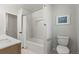 Clean bathroom featuring a tub and shower, complemented by bright, neutral decor at 12017 W 58Th Pl, Arvada, CO 80004