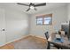 Bedroom featuring a ceiling fan, neutral decor, and a functional workspace, creating a comfortable and productive environment at 12017 W 58Th Pl, Arvada, CO 80004