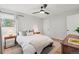 Well-lit bedroom featuring hardwood floors, neutral decor, and a ceiling fan, ideal for relaxation and comfort at 12017 W 58Th Pl, Arvada, CO 80004
