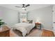 Cozy bedroom with a ceiling fan, neutral decor, and hardwood floors, creating a serene and inviting atmosphere at 12017 W 58Th Pl, Arvada, CO 80004