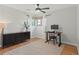 Inviting bedroom with a ceiling fan, neutral decor, and a comfortable workspace at 12017 W 58Th Pl, Arvada, CO 80004