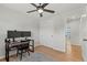Bedroom featuring a ceiling fan, closet, and hardwood floors leading to an open doorway at 12017 W 58Th Pl, Arvada, CO 80004