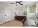 Bedroom featuring a ceiling fan, neutral decor, and a functional workspace at 12017 W 58Th Pl, Arvada, CO 80004