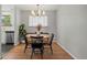 Dining room with modern lighting and sleek, minimalist furniture at 12017 W 58Th Pl, Arvada, CO 80004