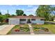 Charming home featuring beautiful front yard landscaping and a well-maintained lawn at 12017 W 58Th Pl, Arvada, CO 80004