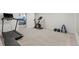 Bright home gym with a treadmill, exercise bike, and weight rack at 12017 W 58Th Pl, Arvada, CO 80004