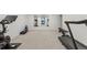 Home gym with mirrored walls, a treadmill, and various workout equipment at 12017 W 58Th Pl, Arvada, CO 80004