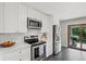 Modern kitchen with stainless steel appliances and sliding door to backyard at 12017 W 58Th Pl, Arvada, CO 80004