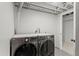 Laundry room showing an LG washer and dryer with an unfinished ceiling at 12017 W 58Th Pl, Arvada, CO 80004