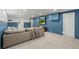 Cozy living room featuring comfortable seating and a TV on a blue accent wall at 12017 W 58Th Pl, Arvada, CO 80004