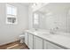 Bathroom features double sinks, quartz countertop, large mirror, and hardwood-style floors at 6636 N Nepal St, Aurora, CO 80019