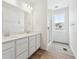 Bathroom features double sinks, quartz countertop, large mirror, and glass enclosed shower at 6636 N Nepal St, Aurora, CO 80019