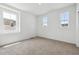 Clean, bright bedroom with neutral carpet, fresh paint and three large windows allowing natural light at 6636 N Nepal St, Aurora, CO 80019