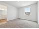 Bedroom with neutral carpet is attached to a bright bathroom with neutral paint at 6636 N Nepal St, Aurora, CO 80019