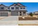 Charming two-story home with a gray exterior, a two-car garage, and a welcoming front porch at 6636 N Nepal St, Aurora, CO 80019