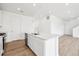 Contemporary kitchen showcases quartz counters, stainless appliances, and luxury vinyl plank flooring at 6636 N Nepal St, Aurora, CO 80019