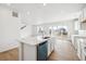 Modern kitchen with stainless steel appliances, a center island, and sliding glass doors to the outside at 6636 N Nepal St, Aurora, CO 80019