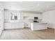 Bright kitchen features a large island with quartz countertop, stainless steel appliances and hardwood floors at 6636 N Nepal St, Aurora, CO 80019