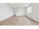 Bright living room features wood-look flooring, a staircase, and large windows that let in plenty of sunlight at 6636 N Nepal St, Aurora, CO 80019