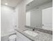 Well-lit bathroom with a granite countertop and shower over tub with white tile surround at 7330 Green River Ave, Frederick, CO 80530