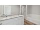 Bathroom featuring double sinks, granite counters, a soaking tub, and a glass shower at 7330 Green River Ave, Frederick, CO 80530