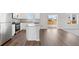 Well-lit kitchen features wood floors, stainless steel appliances, and access to a patio at 7330 Green River Ave, Frederick, CO 80530