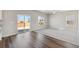 Spacious living room with a ceiling fan, carpet and wood flooring, and a sliding glass door to the yard at 7330 Green River Ave, Frederick, CO 80530